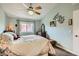 Charming main bedroom with ceiling fan, neutral paint, and large window at 209 Crosswind Way, Las Vegas, NV 89145