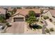 Expansive aerial view of home showcasing mature landscaping, covered patio, and desert surroundings at 2606 Crested Butte St, Henderson, NV 89052