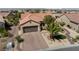 Stunning aerial view of a single-story home featuring manicured landscaping, a covered patio, and desert surroundings at 2606 Crested Butte St, Henderson, NV 89052
