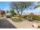 Private backyard with desert landscaping, artificial turf, a hot tub, and seating areas for entertaining at 2606 Crested Butte St, Henderson, NV 89052