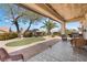 Serene backyard with covered patio, lush landscaping, and charming outdoor seating area at 2606 Crested Butte St, Henderson, NV 89052