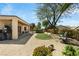 Lush backyard featuring a covered patio, outdoor furniture, and mature trees at 2606 Crested Butte St, Henderson, NV 89052