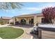 Beautiful backyard with a covered patio, small patch of artifical grass, and a relaxing hot tub at 2606 Crested Butte St, Henderson, NV 89052