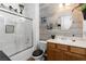 Bathroom featuring a shower over tub combo, white vanity, and modern decor at 2606 Crested Butte St, Henderson, NV 89052