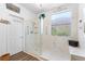 Modern bathroom featuring a glass-enclosed shower, tiled walls, and a window providing natural light at 2606 Crested Butte St, Henderson, NV 89052
