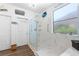 Bright bathroom with clear glass shower, nautical decor and a bright window at 2606 Crested Butte St, Henderson, NV 89052