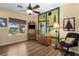 Unique bedroom featuring creative decor, a ceiling fan, and a large window at 2606 Crested Butte St, Henderson, NV 89052