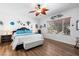 Relaxing bedroom featuring a queen size bed, hardwood floors, and bright window at 2606 Crested Butte St, Henderson, NV 89052