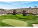Scenic view of a community entrance with lush greenery, a well-maintained golf course, and serene landscaping at 2606 Crested Butte St, Henderson, NV 89052