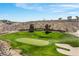 Community entrance with manicured landscaping and an immaculate green fairway at 2606 Crested Butte St, Henderson, NV 89052