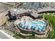 An aerial view shows the community pool with surrounding buildings, trees, and shade umbrellas at 2606 Crested Butte St, Henderson, NV 89052