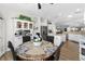Bright dining area with a table set for four next to an open kitchen with an island at 2606 Crested Butte St, Henderson, NV 89052