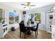 Dining room with wood floors, windows with shutters, and a table set for dinner at 2606 Crested Butte St, Henderson, NV 89052