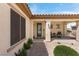 Charming front porch with desert landscaping, decorative plants, and comfortable seating area at 2606 Crested Butte St, Henderson, NV 89052