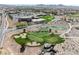 Aerial view of a picturesque golf course and water feature landscaping next to a community center at 2606 Crested Butte St, Henderson, NV 89052