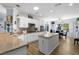 Bright kitchen featuring white cabinets, granite countertops, stainless steel appliances, and an island at 2606 Crested Butte St, Henderson, NV 89052