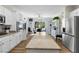 Bright kitchen features white cabinetry, stainless steel appliances, and a large island at 2606 Crested Butte St, Henderson, NV 89052