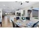 Open-concept kitchen/dining area with stainless appliances and natural light from backyard window at 2606 Crested Butte St, Henderson, NV 89052