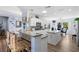Bright kitchen featuring white cabinets, granite countertops, stainless steel appliances, and an island with breakfast bar at 2606 Crested Butte St, Henderson, NV 89052