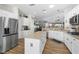 Spacious kitchen features white cabinets, stainless steel appliances, and a center island at 2606 Crested Butte St, Henderson, NV 89052