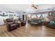 Spacious living room featuring hardwood floors, comfortable seating, and bright natural light at 2606 Crested Butte St, Henderson, NV 89052