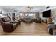 Large living room showcasing wood-look flooring, comfortable seating, a fireplace, and access to the backyard at 2606 Crested Butte St, Henderson, NV 89052