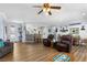 Spacious living room featuring hardwood floors, a ceiling fan, and an open layout at 2606 Crested Butte St, Henderson, NV 89052