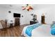 Open bedroom featuring hardwood floors, large window, closet and bright accents at 2606 Crested Butte St, Henderson, NV 89052