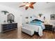 Bright main bedroom featuring a queen size bed, hardwood floors, and an attached bath at 2606 Crested Butte St, Henderson, NV 89052