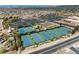 Overhead view of multiple tennis courts with surrounding greenery near a community center, showcasing the community's recreational amenities at 2606 Crested Butte St, Henderson, NV 89052