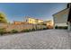 A spacious backyard showcasing lovely brick pavers and an attractive wall, providing privacy and aesthetic appeal at 2669 Via Monet, Henderson, NV 89044