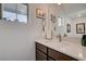 Modern bathroom with a vanity, quartz countertop, stylish fixtures, and ample natural light at 2669 Via Monet, Henderson, NV 89044