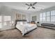 Bright bedroom features a ceiling fan, neutral color palette, and natural light from the window at 2669 Via Monet, Henderson, NV 89044