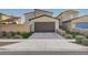 Charming home exterior with a well-manicured yard and a brick-paved driveway leading to a convenient two-car garage at 2669 Via Monet, Henderson, NV 89044