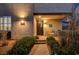 Inviting front entrance with a cozy sitting area and brick pathway surrounded by lush landscaping at 2669 Via Monet, Henderson, NV 89044