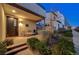 Inviting front entrance featuring a cozy bench, lush greenery, and an attractive facade, enhancing curb appeal at 2669 Via Monet, Henderson, NV 89044