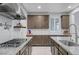 Elegant kitchen with granite countertops, tile backsplash, stainless steel appliances and modern fixtures at 2669 Via Monet, Henderson, NV 89044