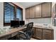 Comfortable office space featuring built in cabinets, a large wooden desk, and natural light at 2669 Via Monet, Henderson, NV 89044