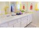Bathroom featuring double sinks with white cabinets and stylish fixtures with floral decorations at 2801 Peggy Ave, Pahrump, NV 89048