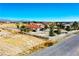 Cozy residence boasts mature landscaping and a white picket fence, enhancing its curb appeal at 2801 Peggy Ave, Pahrump, NV 89048