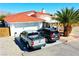 Charming single-story home featuring an attached garage, red tile roof, and desert landscaping at 2801 Peggy Ave, Pahrump, NV 89048
