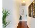 Inviting hallway featuring rich wood floors and decorated with plants and art at 2801 Peggy Ave, Pahrump, NV 89048