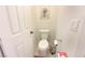 Powder room featuring a standard toilet, white door, and light walls with a neutral color scheme at 2801 Peggy Ave, Pahrump, NV 89048