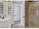 Bathroom with glass shower and double sinks with white cabinets and bronze hardware at 2877 Paradise Rd # 2704, Las Vegas, NV 89109