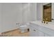 Neutral toned powder bathroom with white cabinet, marbled countertop, and bronze fixtures at 2877 Paradise Rd # 2704, Las Vegas, NV 89109