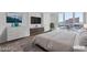 Modern bedroom with dresser, television, and large windows allowing natural light into the room at 2877 Paradise Rd # 2704, Las Vegas, NV 89109