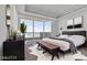 Bright bedroom with bench at foot of bed and artwork on walls at 2877 Paradise Rd # 2704, Las Vegas, NV 89109