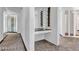 Hallway with white walls and gray carpet, featuring a unique built-in bar area, and a wall of windows letting in natural light at 2877 Paradise Rd # 2704, Las Vegas, NV 89109
