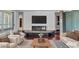 Spacious living room with dark wood floors, white couches, and fireplace beneath mounted television at 2877 Paradise Rd # 2704, Las Vegas, NV 89109