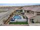 Stunning backyard with a sparkling pool, lush landscaping, and outdoor entertaining areas in a beautiful location at 3000 Raywood Ash Dr, Las Vegas, NV 89138